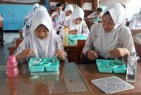 Siswa SMPN 2 ciamis tengah menikmati makan bergizi gratis.